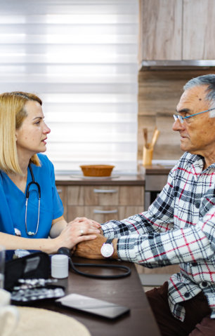 caregiver holding hands of elderly