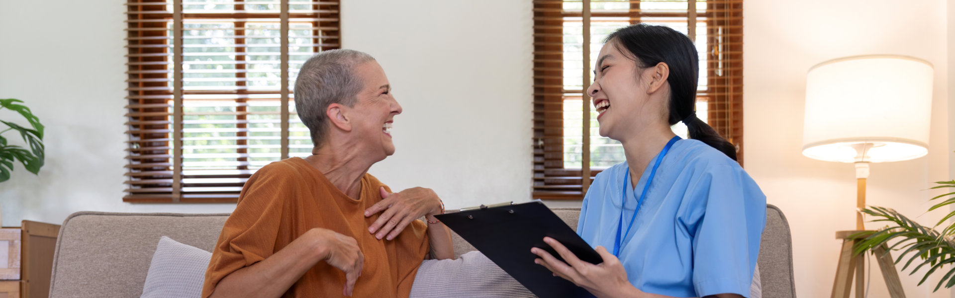 caregiver and elderly laughing