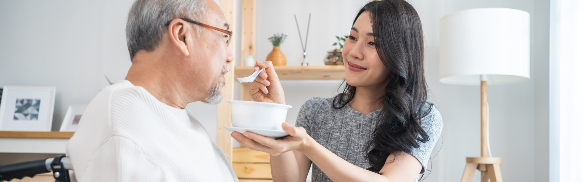 caregiver feeding elderly