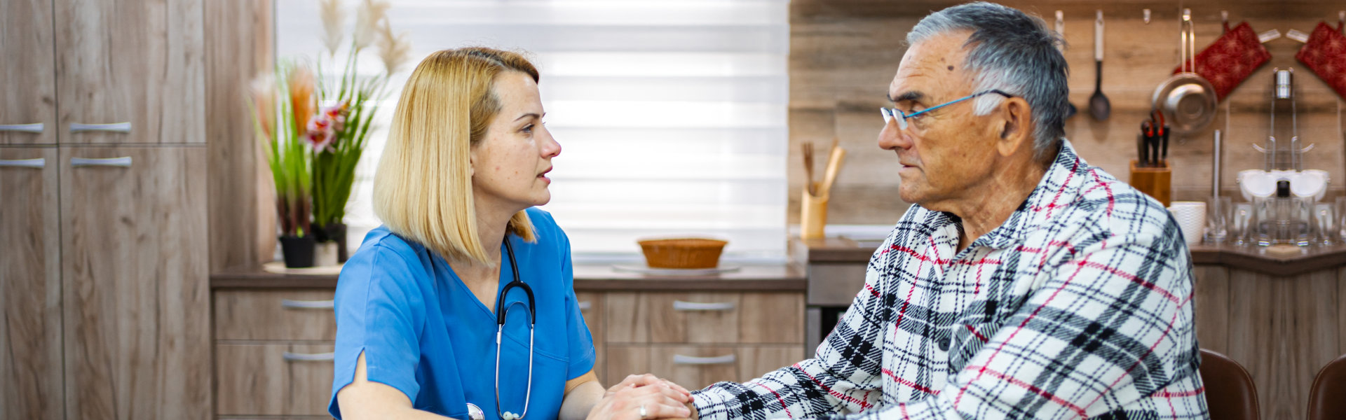 caregiver holding hands of elderly
